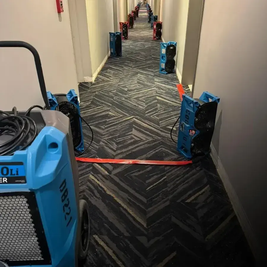 Dehumidifiers drying a long apartment building hallway