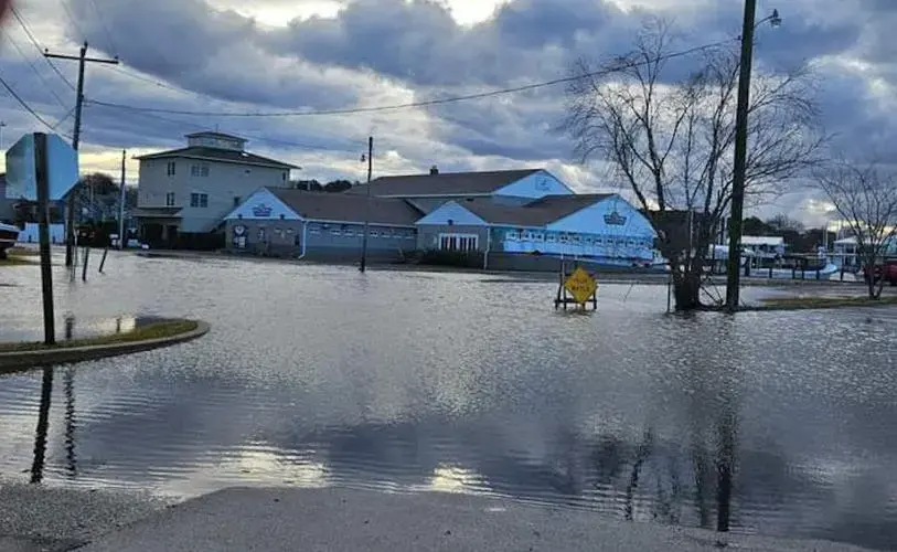 Flooded street and homes after a heavy storm, the start of flash flood cleanup
