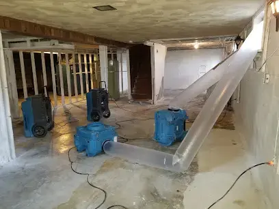 Air movers, dehumidifiers and poly ducting during structural drying of a basement