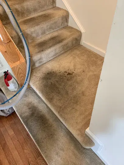 Extraction wand pulling water out of wet stair carpet during water extraction